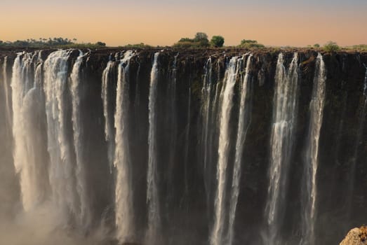 Victoria Falls on the Zambezi River between Zimbabwe and Zambia, at sunset