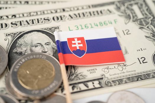 Stack of coins with Slovakia flag on USA America dollar banknotes.