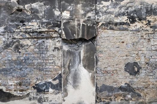 Wall in a steel mill with clear signs of use, cracks and pipes. High resolution background