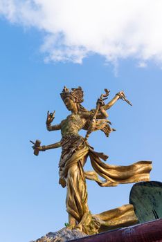 Six handed Bali goddes of dance statue against blue sky