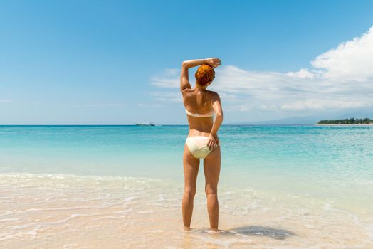 Young sexy woman wearing bikini at the tropical beach