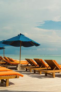 Lots of sunbeds with umbrellas at the ocean beach