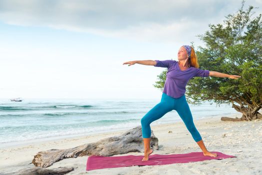 Young woman practicing yoga at exotic Bali location