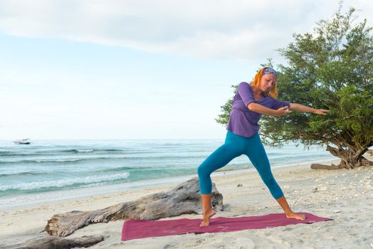 Young woman practicing yoga at exotic Bali location