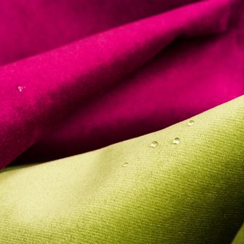 Macro shot of fine fabric texture background with water drops