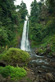 Beautiful tall waterfall deep in Bali jungle