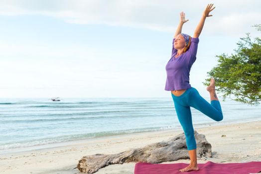 Young woman practicing yoga at exotic Bali location