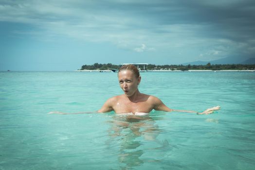 Woman at tropical island beach - filtered effect