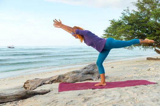 Young woman practicing yoga at exotic Bali location