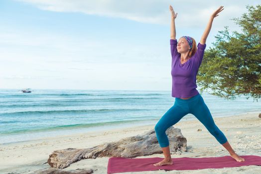 Young woman practicing yoga at exotic Bali location