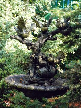 Beautiful decorative bronze fountain in the garden. High quality photo