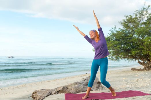 Young woman practicing yoga at exotic Bali location