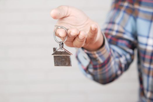 the concept of finance concept , man holding house in hand .