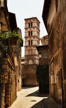 Bell tower of the Collegiate church of Santa Maria Assunta ,gothic church in Sermoneta ,view from narrow street