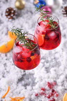 Cocktail Margarita with cranberries, orange and rosemary. A perfect cocktail for a Christmas party
