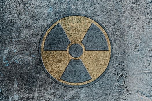 Radiation hazard warning sign depicted on a concrete wall