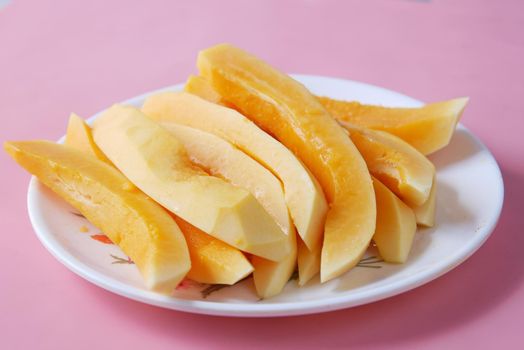 slice of papaya on white plate