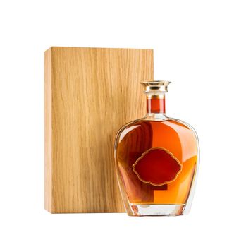 Exclusive cognac bottle with wooden box package isolated on white