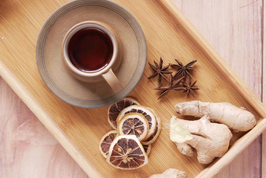 Top view of ginger tea on wooden background..