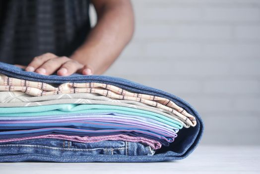 close up of stack of clothes on table