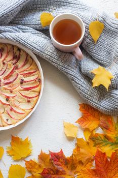 Apple pie layout and autumn leaves top view . An article about autumn. An article about baking. Homemade cakes. Autumn picture