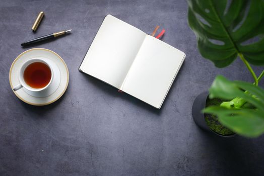 high angle view of open notepad on black background.