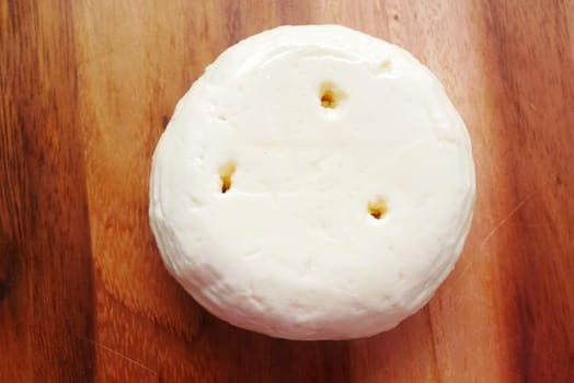 close up of fresh cheese on white background