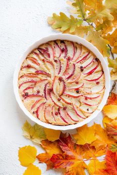 Apple pie layout and autumn leaves top view . An article about autumn. An article about baking. Homemade cakes. Autumn picture