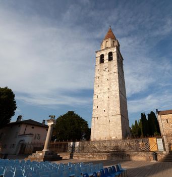 Aquileia, italy - August, 15: View of the Capitoline Wolf under the Bell tower of the Basilica di Santa Maria Assunta on August 15, 2021