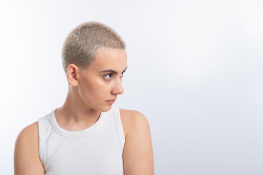 Young caucasian woman with short hair on a white background