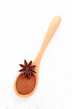 Close up chinese star anise in wooden spoon isolate on white background. Dried star anise spice fruits top view and copy space.