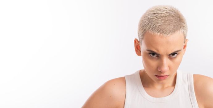 Displeased young caucasian woman with short haircut on white background