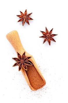 Close up chinese star anise in wooden scoop  isolate on white background. Dried star anise spice fruits top view and copy space.