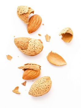 Close up group of almonds nut with shell  and cracked almonds shell isolated on white background.