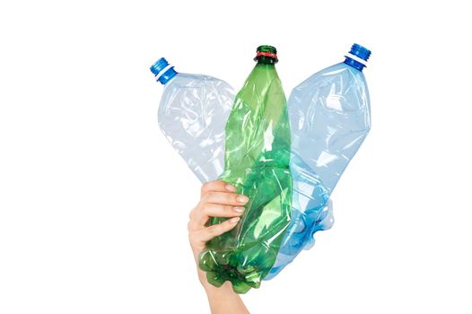 Close-up of a female hand holding plastic bottles on a white background. Isolated.