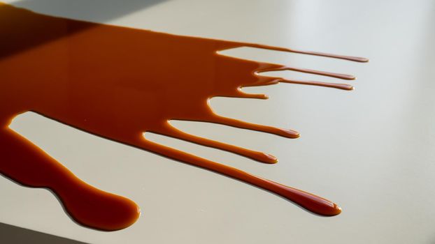 Cup of black coffee spilled on white work table