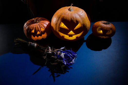 Image of several halloween jack o lanterns glowing in the dark.