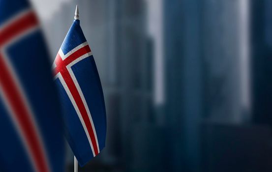 Small flags of Iceland on a blurry background of the city.