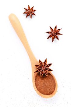 Close up chinese star anise in wooden spoon isolate on white background. Dried star anise spice fruits top view and copy space.