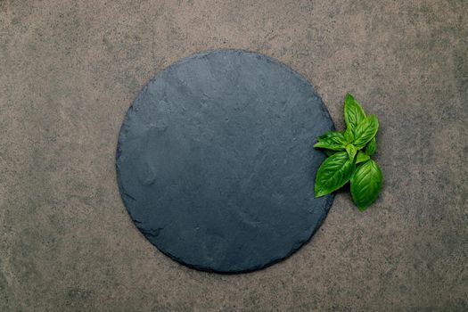 Empty pizza platter for homemade baking set up on dark concrete. Food recipe concept on dark stone background texture with copy space. 