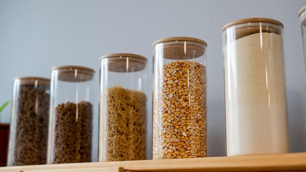 Glass jars with cereals in an eco friendly store. The concept of a grocery store without plastic disposable packaging.