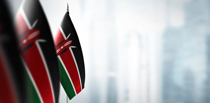 Small flags of Kenya on a blurry background of the city.