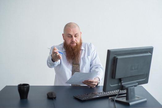 Portrait of a bald man at a desk looking at a report and cursing. The dissatisfied boss dismisses the subordinate