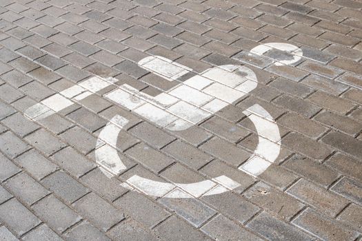 Disabled parking sign in the parking lot close up