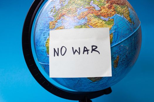 Globe and sticker with the inscription no war
