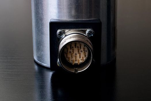 Metal encoder on a black wooden table close up