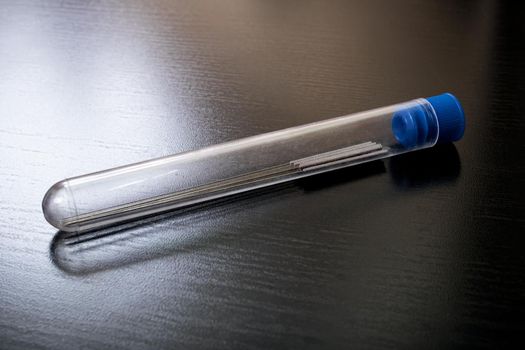Long thin needles in a test tube close up