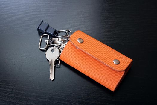 Bunch of keys on a black wooden table