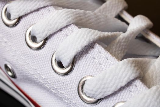 Laces on white sneakers close up, macro photo