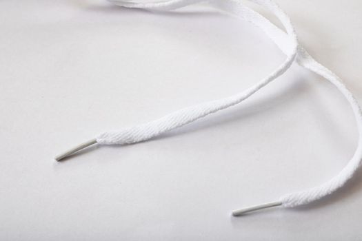 White shoelaces on a white background close up